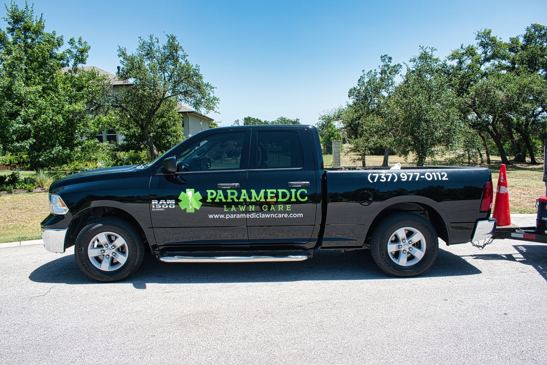 Paramedic Lawn Care truck parked in a residential neighborhood